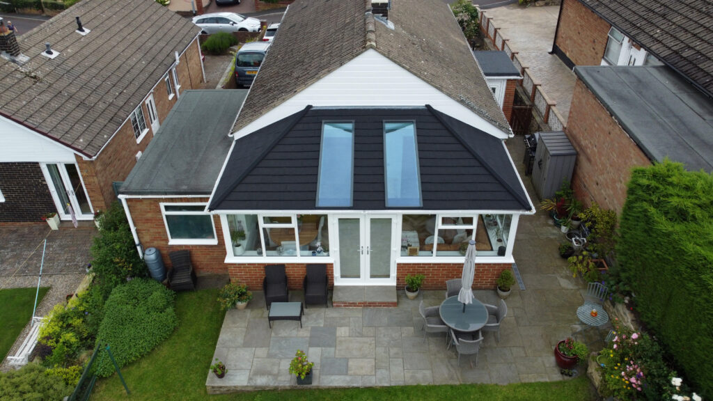 External view of a conservatory roof replacement featuring a Supalite tiled roof system with Skyvista panels