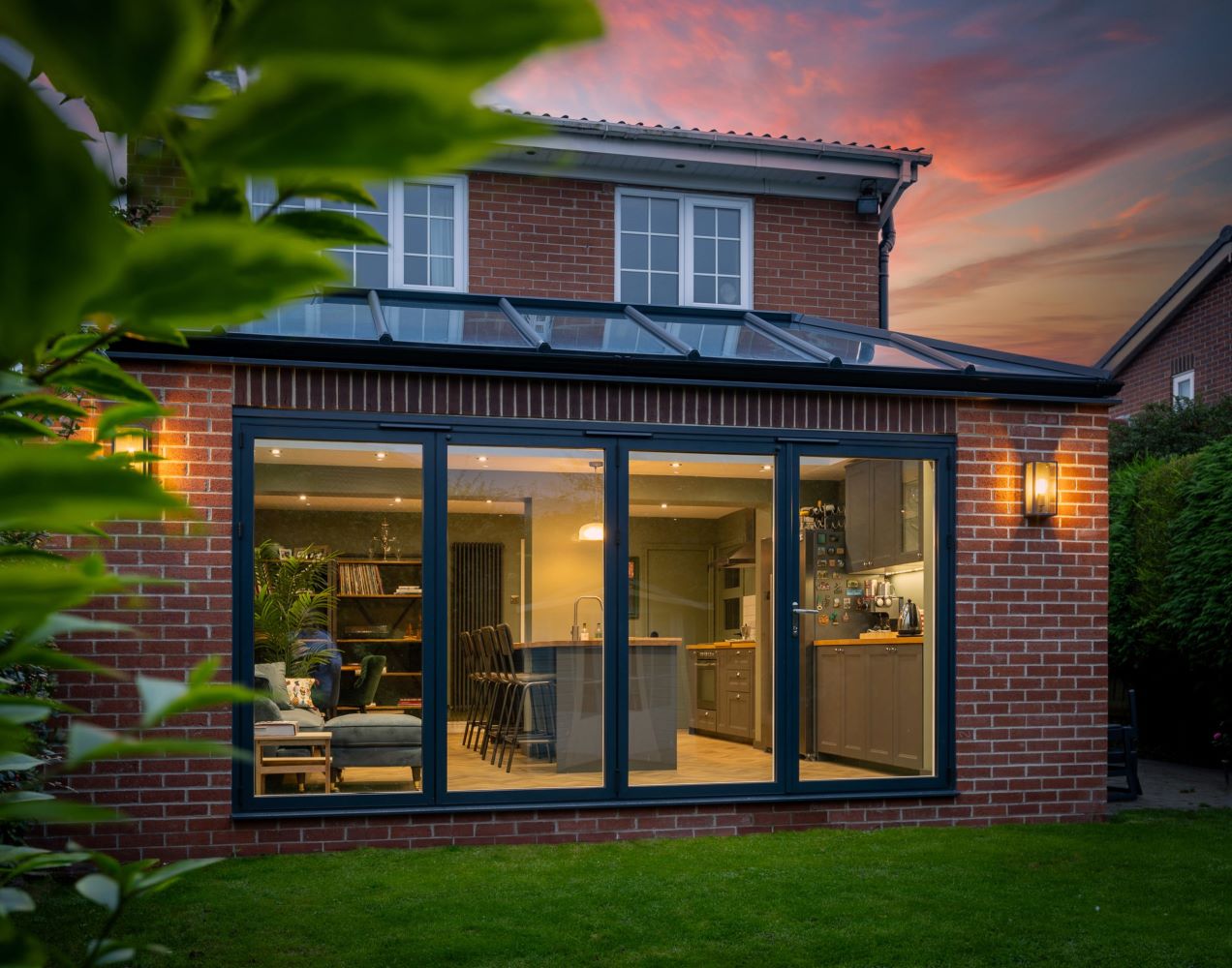the rear of a north east property, sunset behind the house showcasing newly-installed orangery