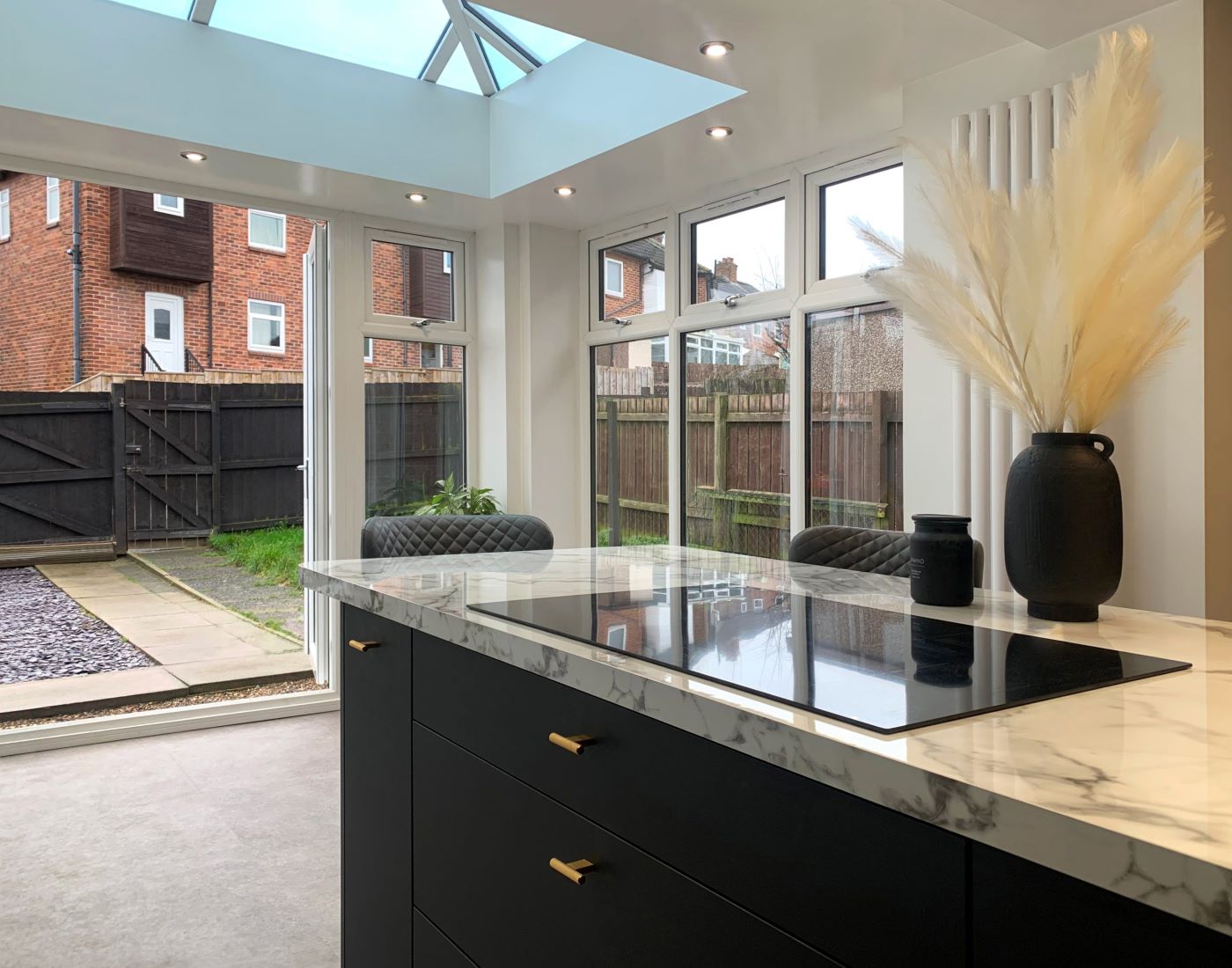 inside of a newly-installed conservatory, with upvc french doors wide open