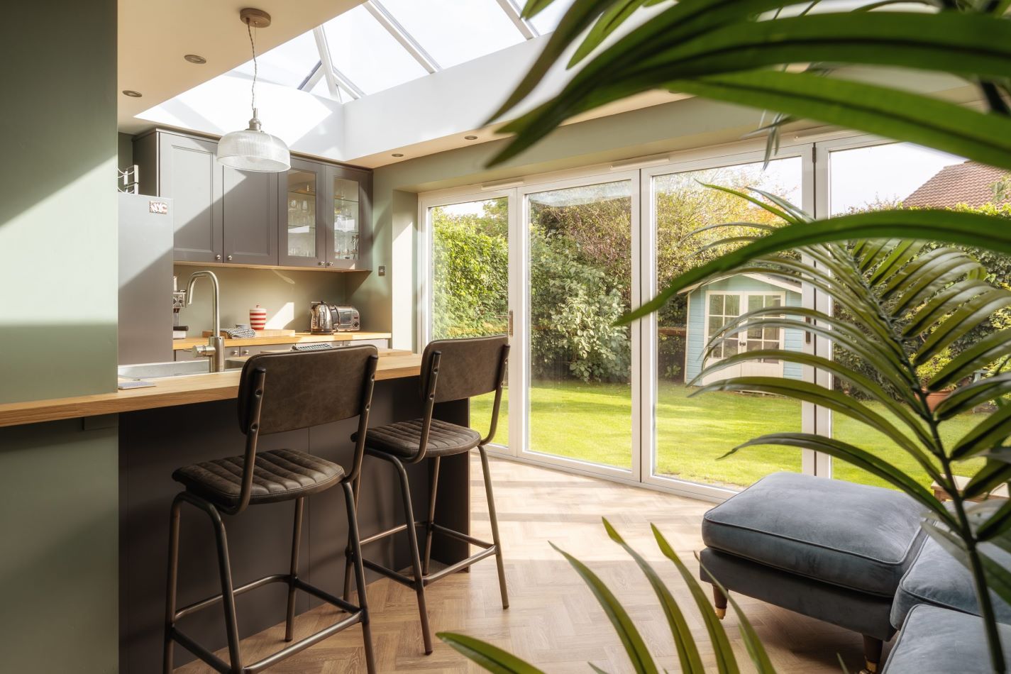 inside of an orangery kitchen extension, with white upvc sliding doors