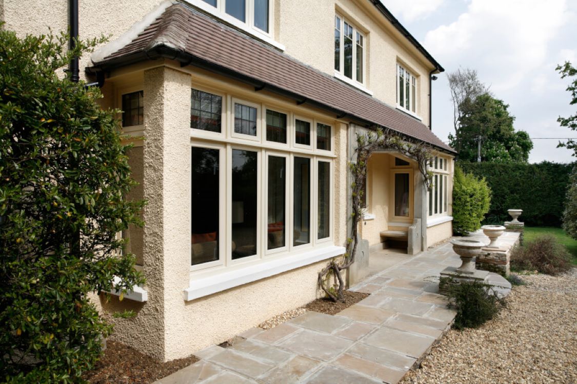 casement windows front of cream house