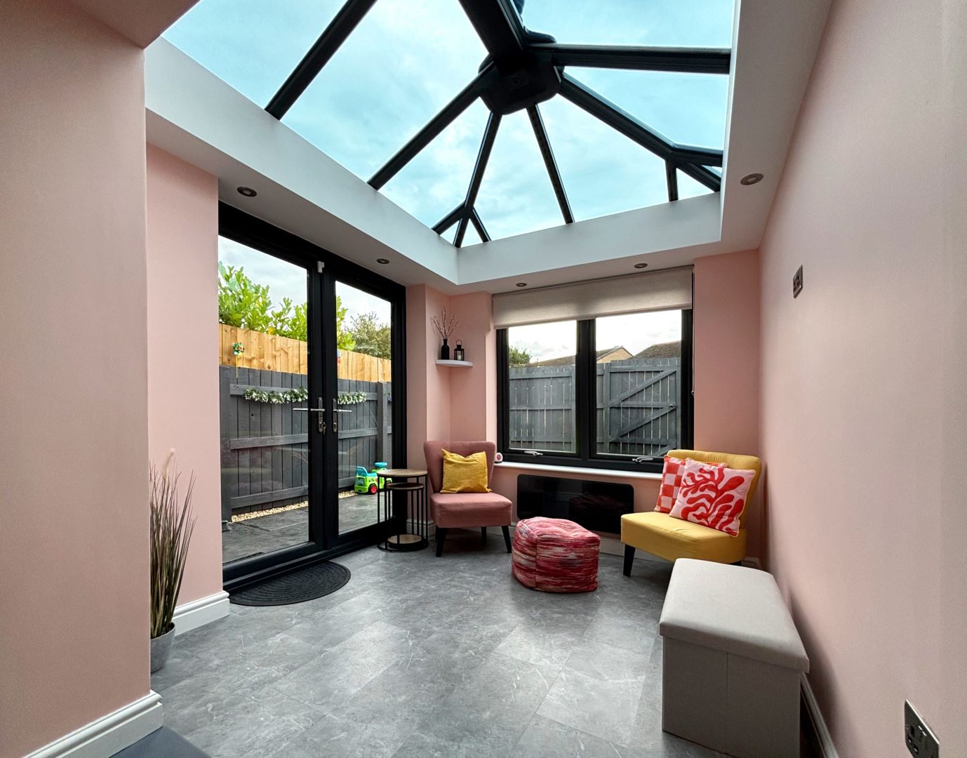 inside modern glazed extension featuring french doors and glass roof