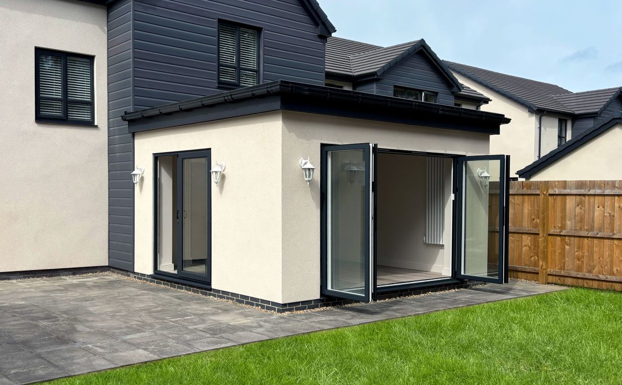 house extension with wide open black french doors